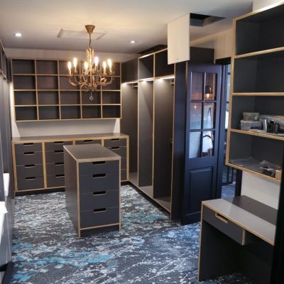 Dark plywood exposed edge walk in wardrobe